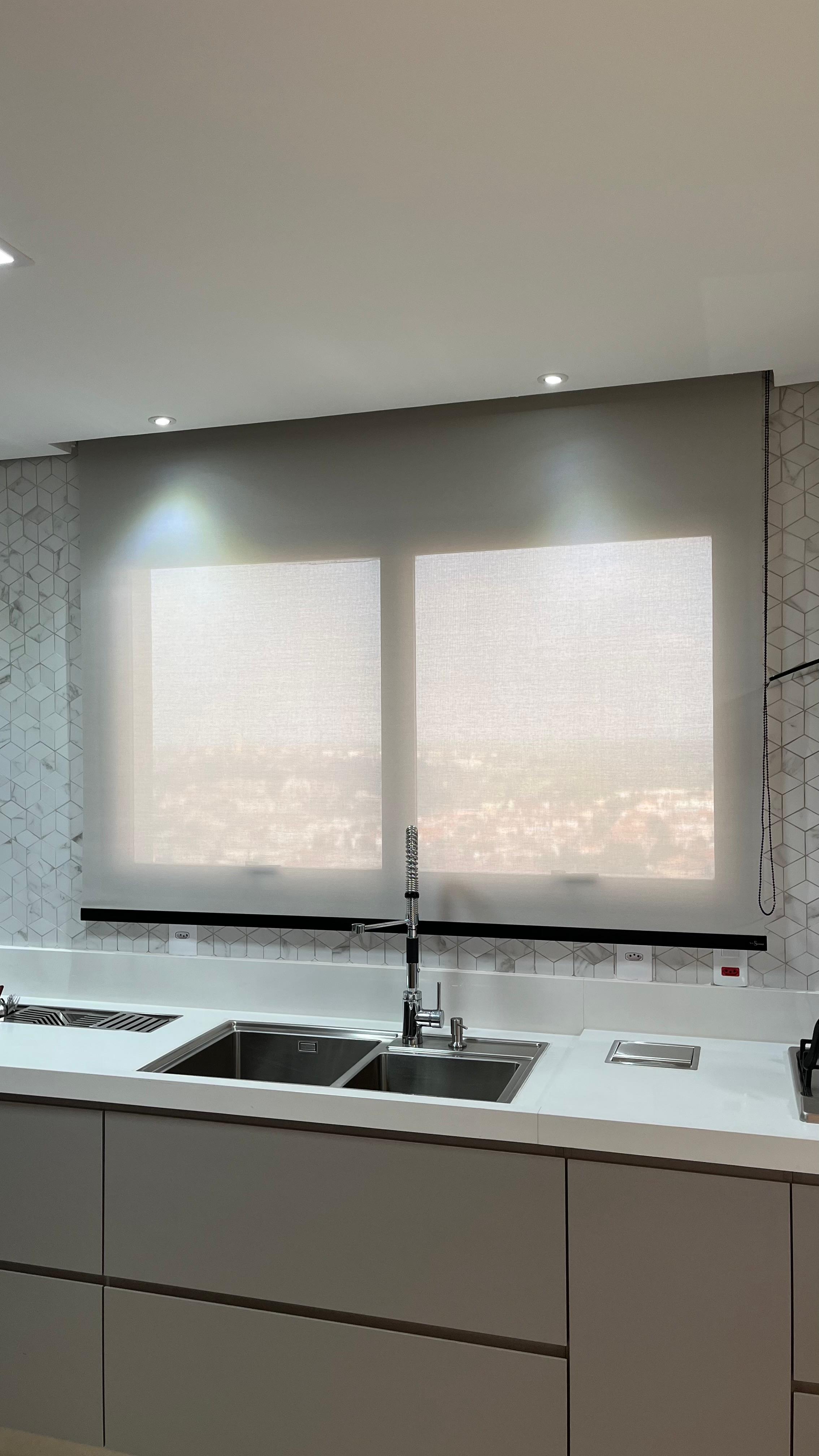 Cortina rolô screen dupla instalada sobre pia de cozinha planejada, trabalho real da SrHouse Decor